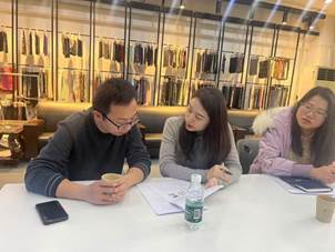 A group of people sitting at a table
Description automatically generated
